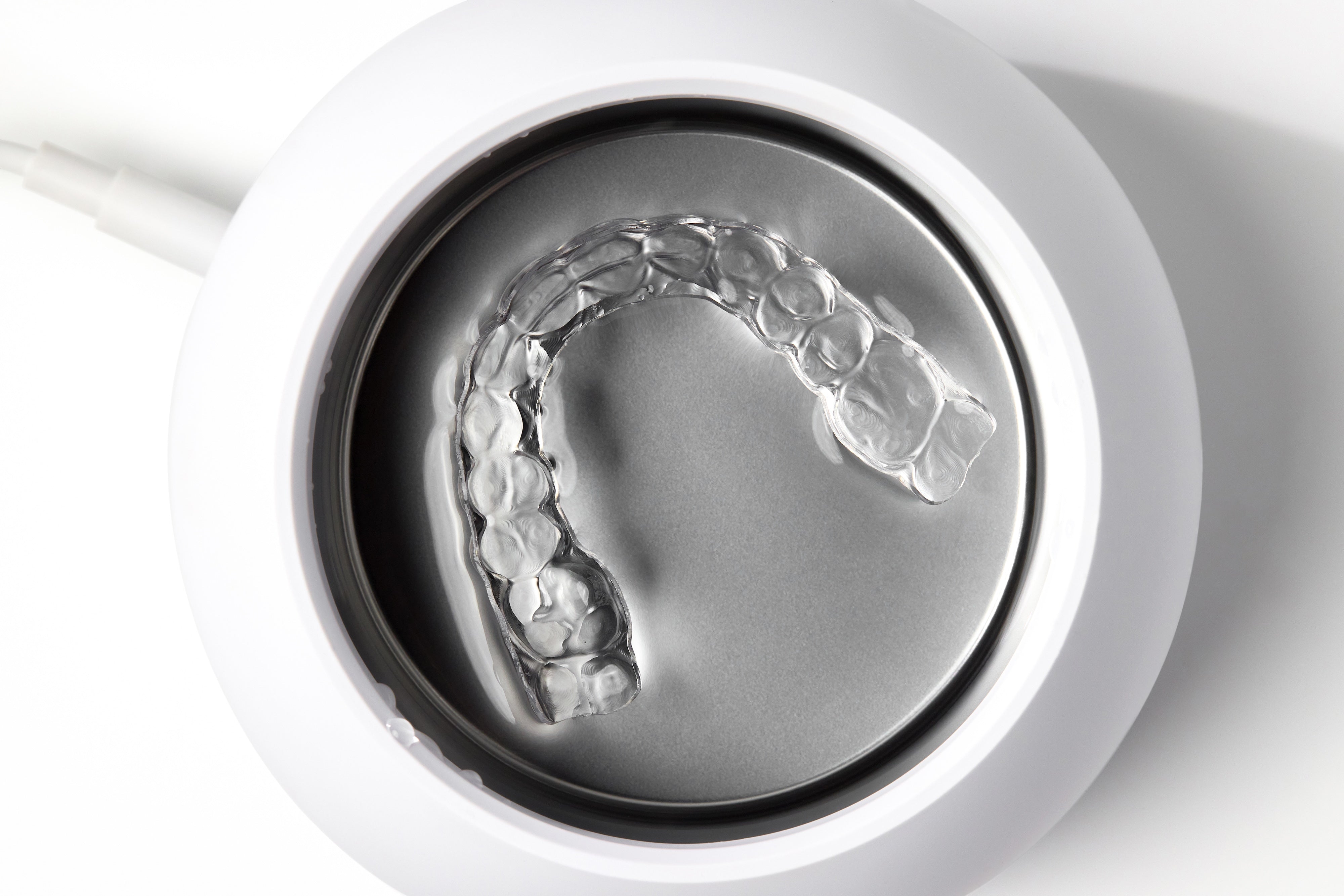 Dentists recommend using an ultrasonic cleaner for aligners